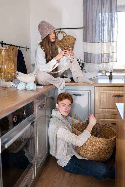 Young couple knitting together