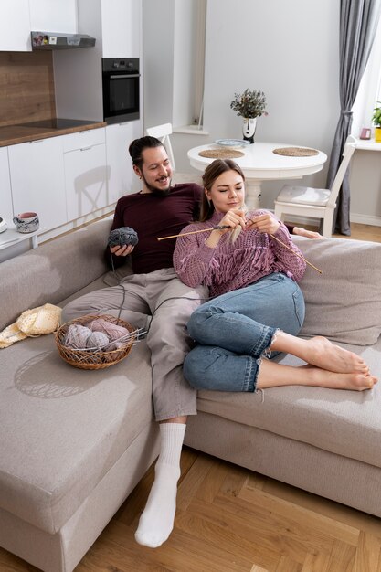 Young couple knitting together