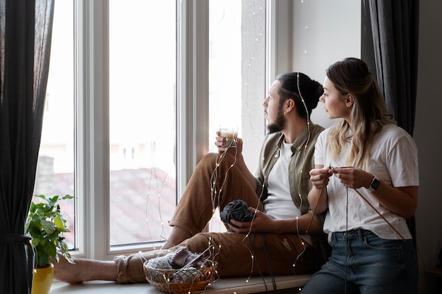 Free photo young couple knitting together