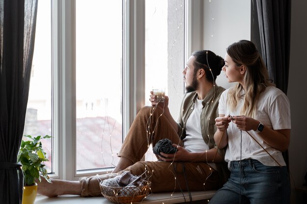 Young couple knitting together