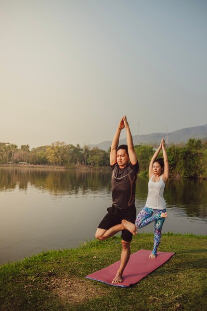 Young couple, landscape and yoga