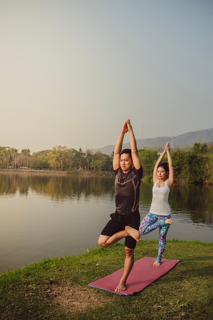 Young couple, landscape and yoga