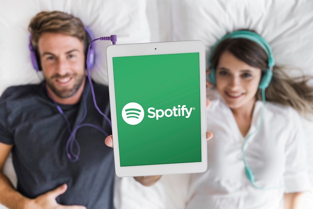 Young couple listening music with spotify app