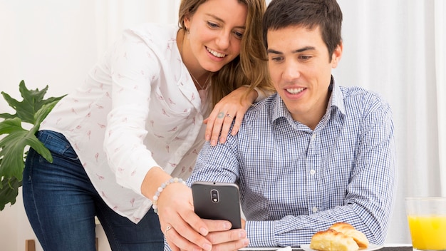 Young couple looking at cell phone