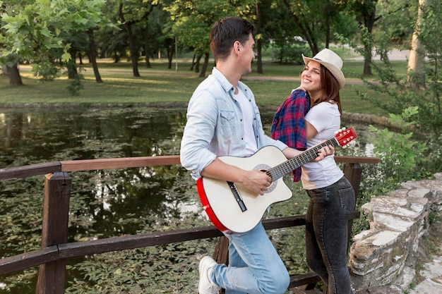 Young couple looking at each other at the bridge