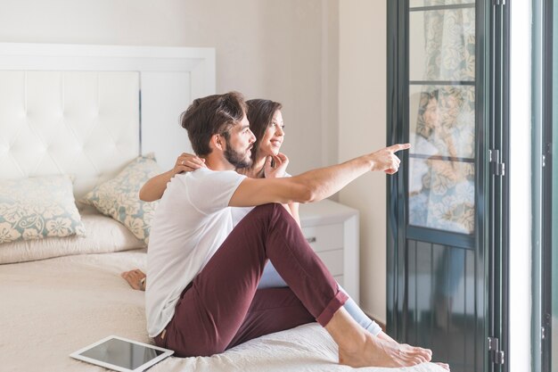 Young couple looking out window