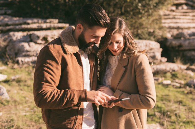 Young couple looking on phone