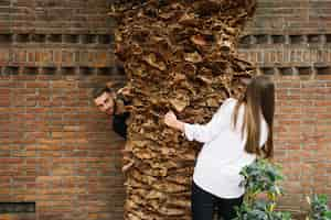 Free photo young couple in love around tree