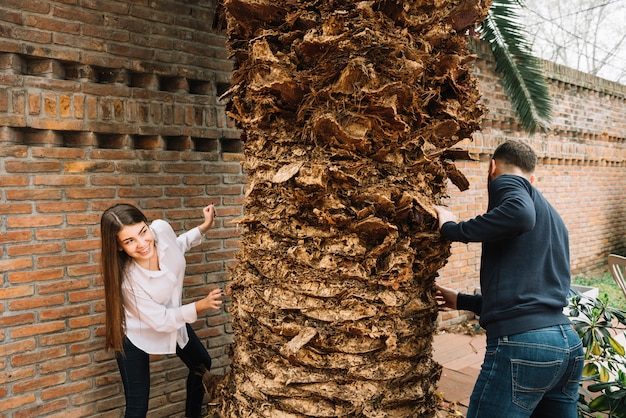 Young couple in love around tree