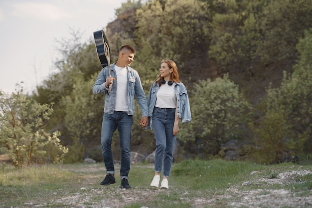 Young couple in love, boyfriend holding a guitar