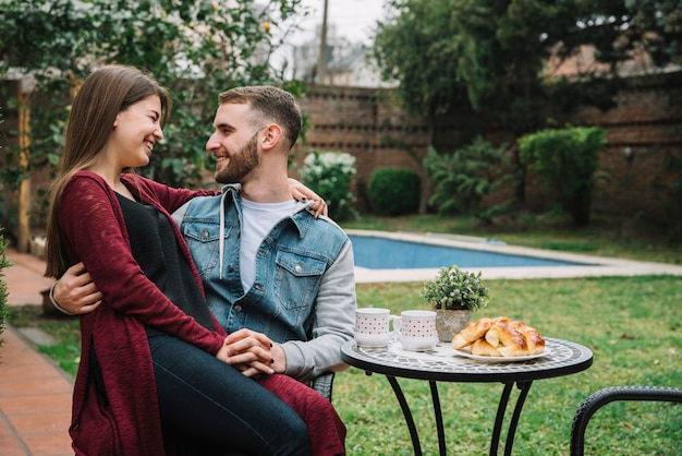 Young couple in love drinking coffee in garden