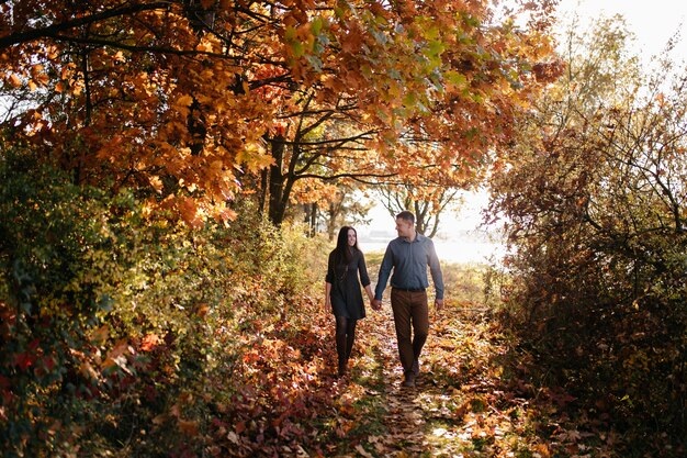 Young couple in love. A love story in the autumn forest park