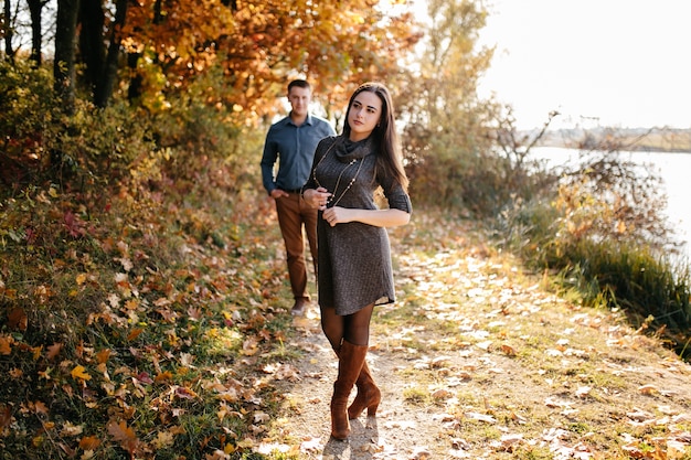 Young couple in love. A love story in the autumn forest park