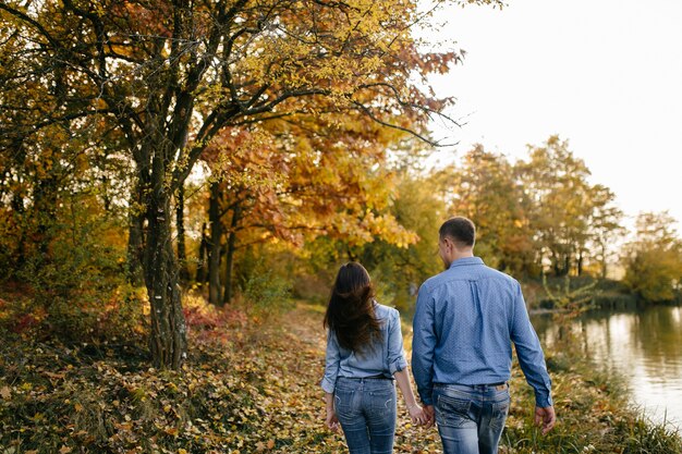 Young couple in love. A love story in the autumn forest park