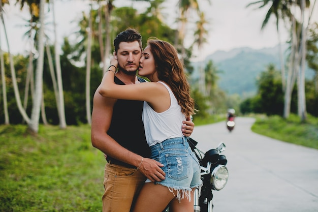 Young couple in love, near a motorcycle