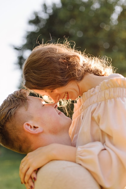 Young couple in love outdoor.Stunning sensual outdoor portrait of young stylish fashion couple posing in summer in field