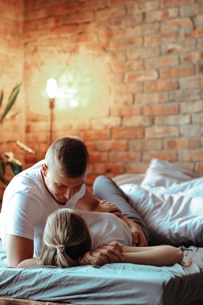 Young couple in love spending time together. Beautiful woman and handsome man having intimate moments at home