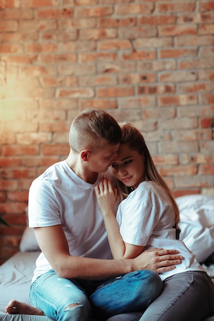 Foto gratuita giovani coppie nell'amore che trascorrono del tempo insieme. bella donna e uomo bello che hanno momenti intimi a casa