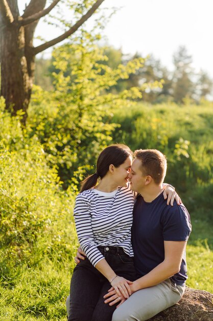 A young couple in love walks in the woods, having a good time together