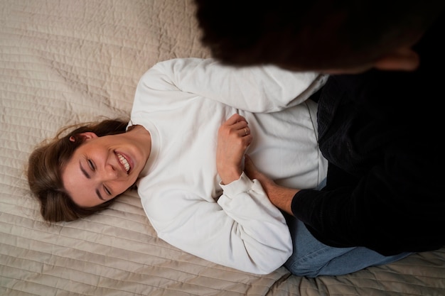 Free photo young couple making each other laugh by tickling