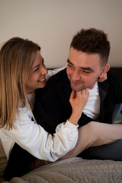 Free photo young couple making each other laugh by tickling