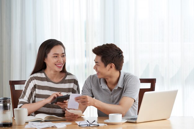 Young couple managing family budget at home