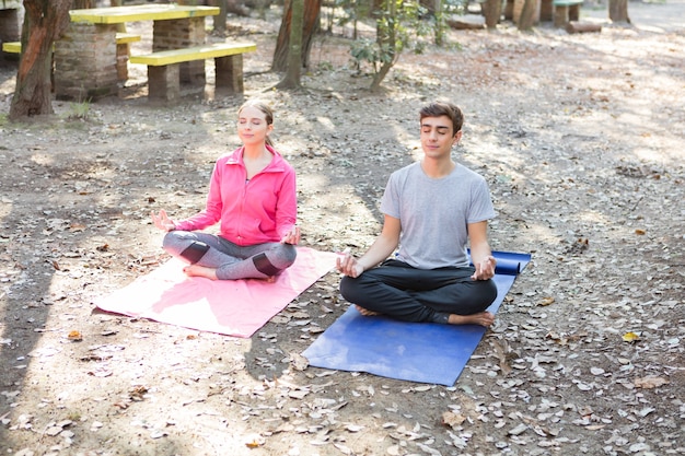 Young couple meditating after a hard week