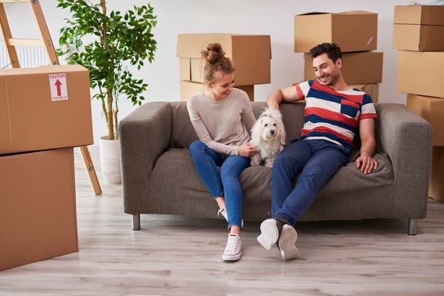 Young couple in new apartment with small dog