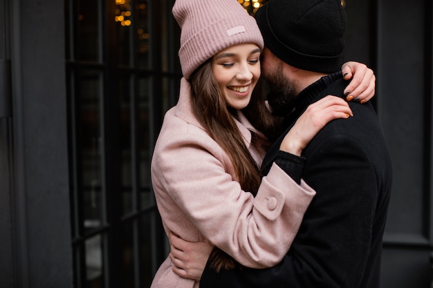 Free photo young couple outdoor hugging