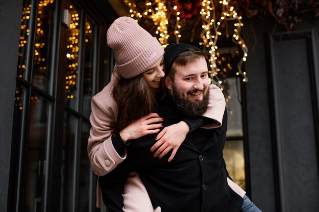young couple outdoor piggy back ride