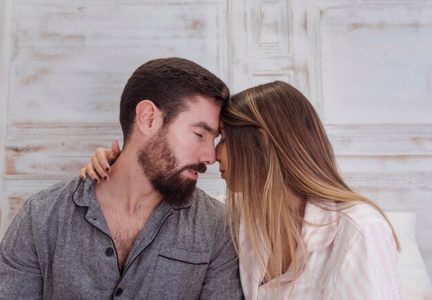 Young couple in pajamas hugging 