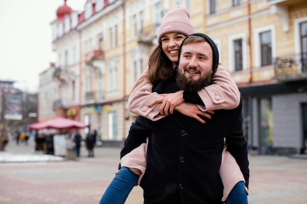 Free photo young couple piggy back ride