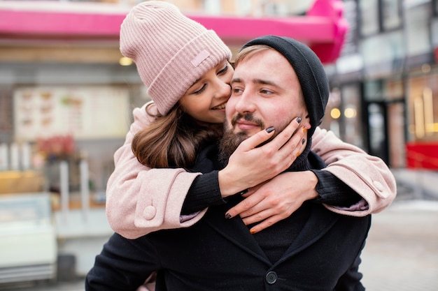 Young couple piggy back ride