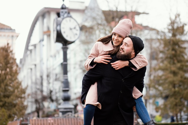 Young couple piggy back ride