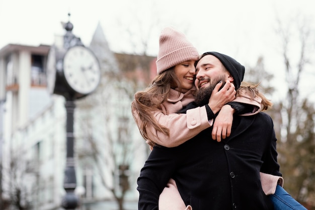 Free photo young couple piggy back ride