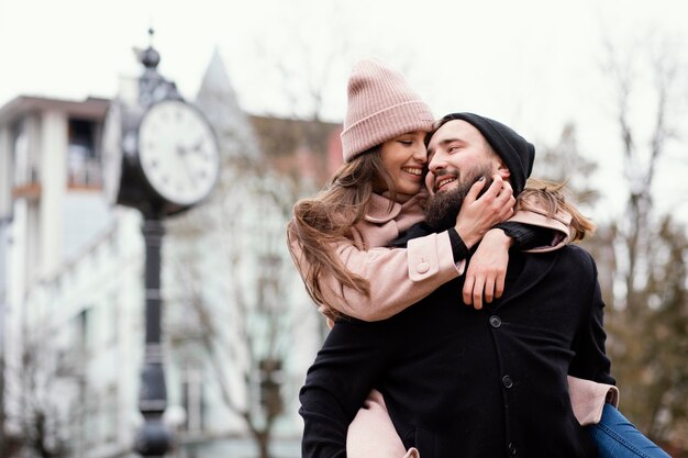 Young couple piggy back ride