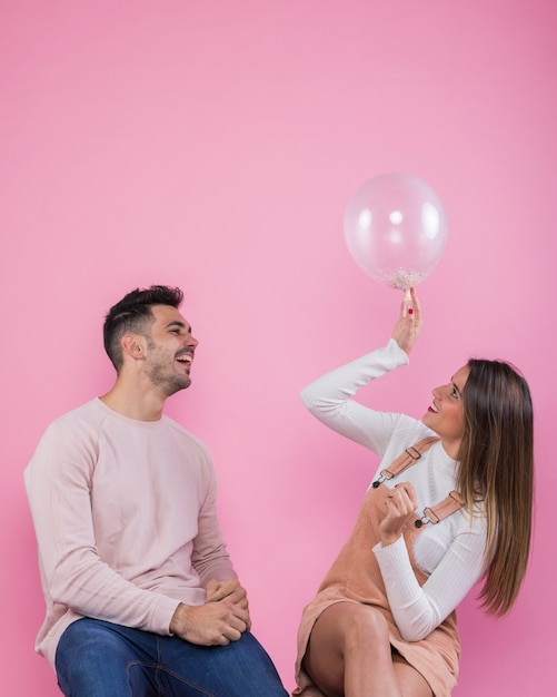 Free photo young couple playing with air balloon