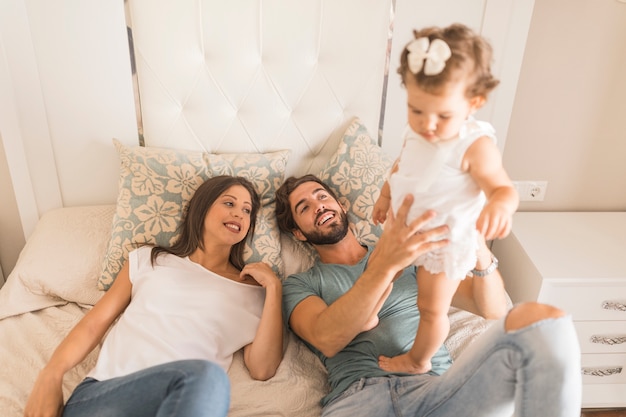 Young couple playing with daughter