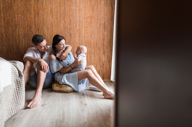 Young couple playing with their baby