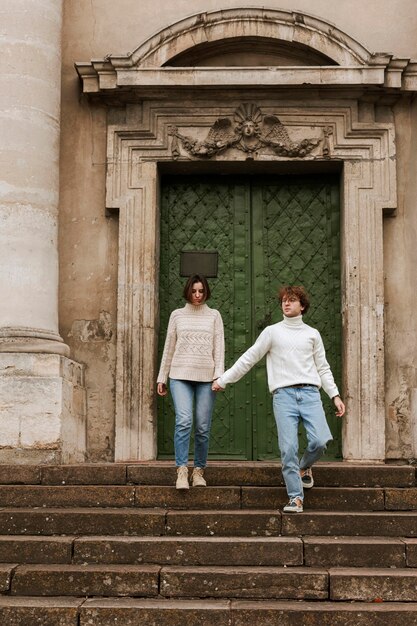 Young couple posing next to a door