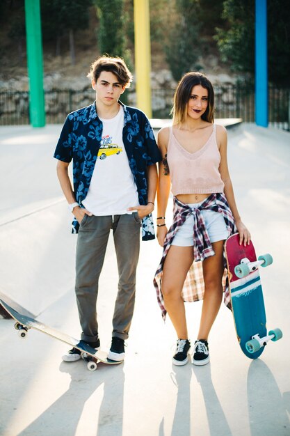 Young couple posing with skateboard