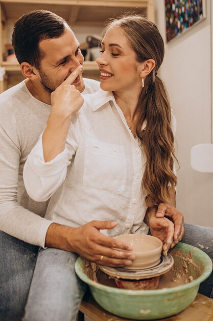 Young couple at a pottery class together