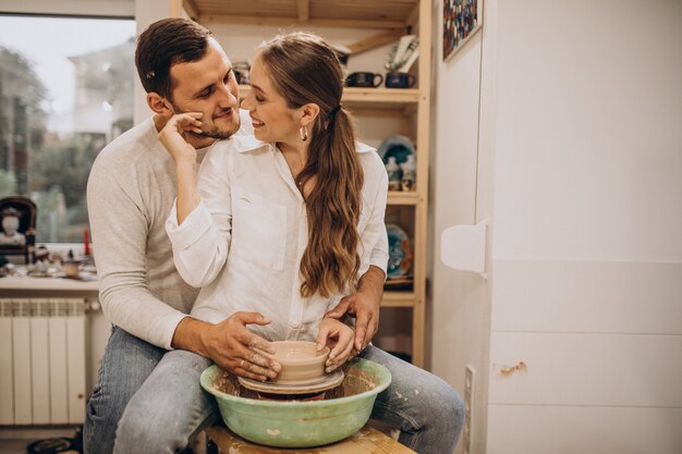 Young couple at a pottery class together