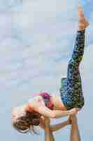 Free photo young couple practicing yoga on city background