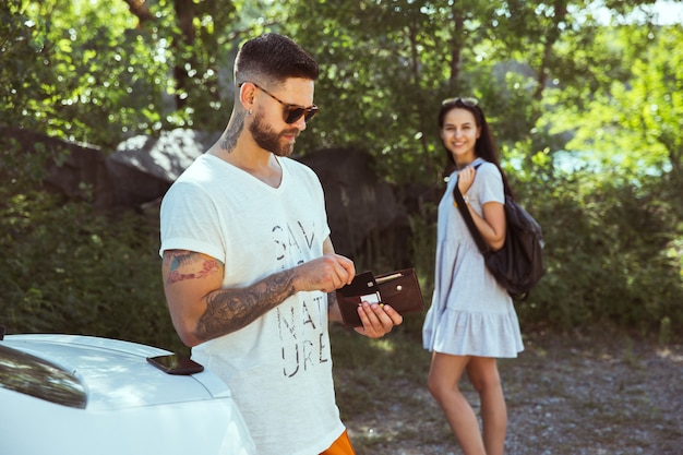 Young couple preparing for vacation in sunny summer's day.