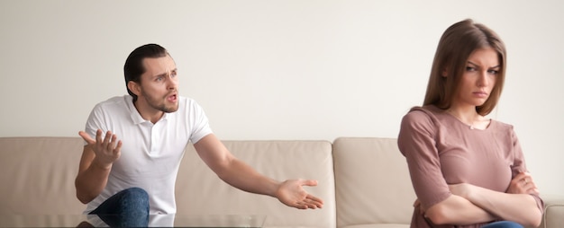 Young couple quarrelling, angry man shouting, woman offended, horizontal banner