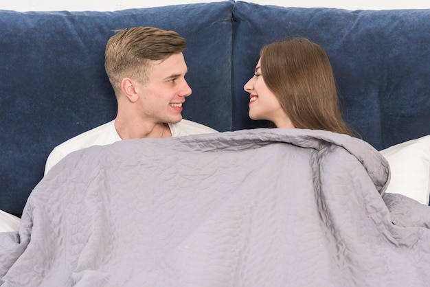 Young couple resting in bed 