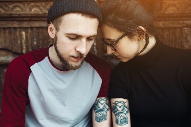 Free photo young couple sharing tattoo