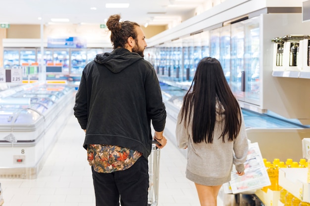 Young couple on shopping in supermarket