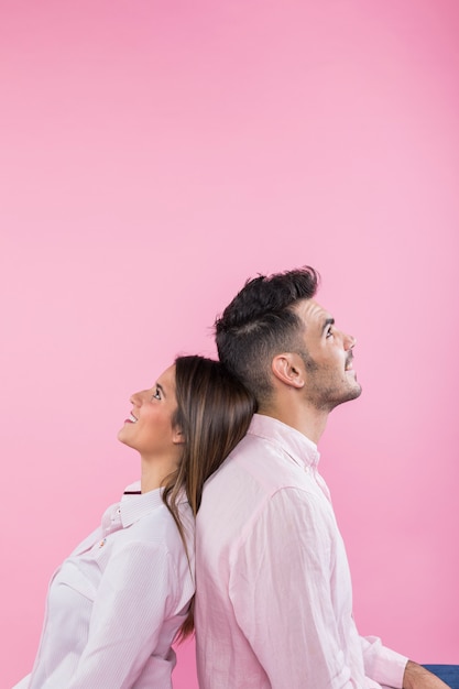 Young couple sitting back to back